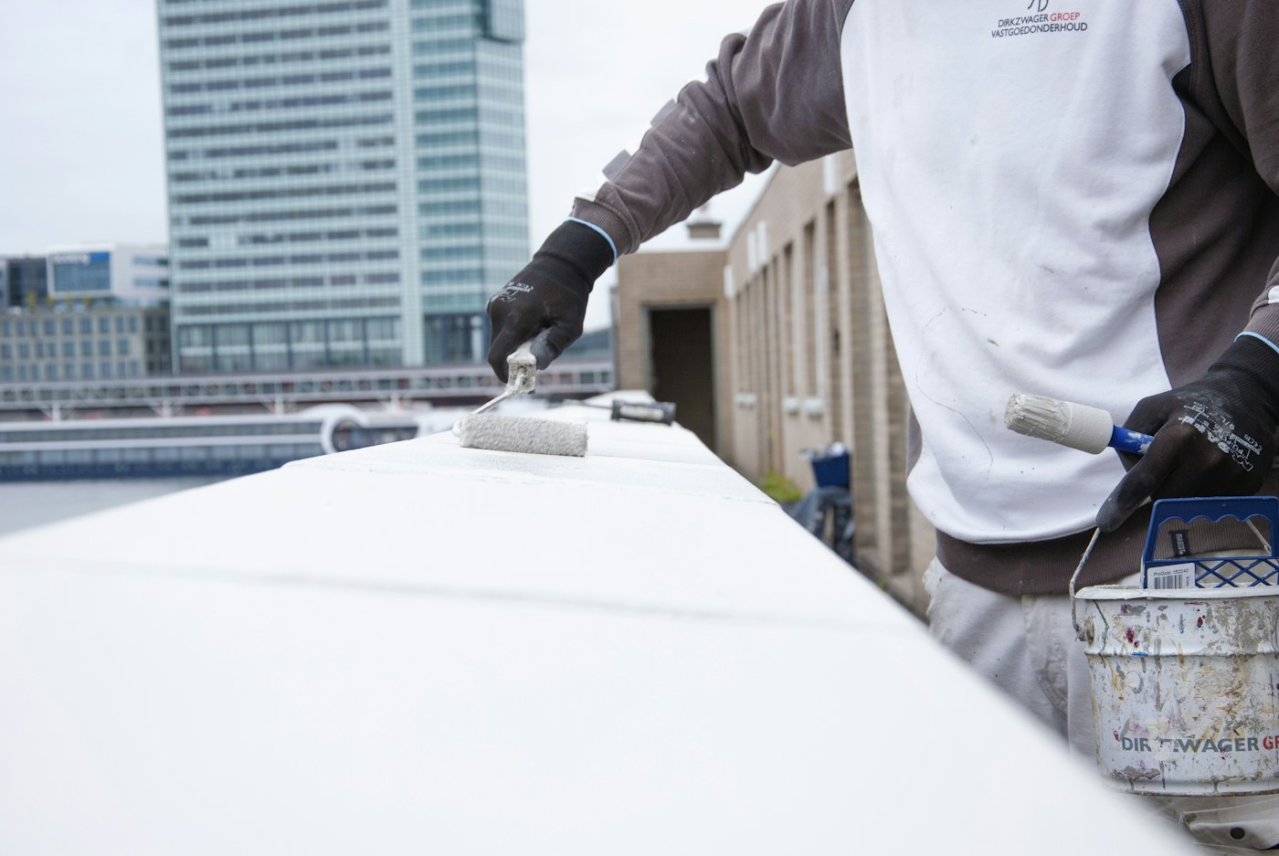 Professional painter applying paint to an interior wall